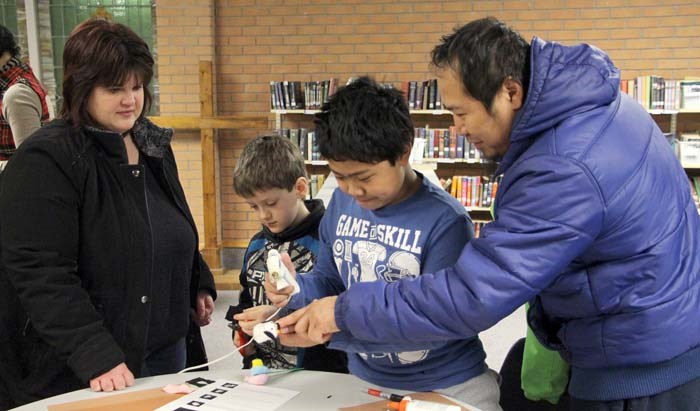 Families take the chance to make a dog bookmark as part of St. Paul’s School’s literacy night.