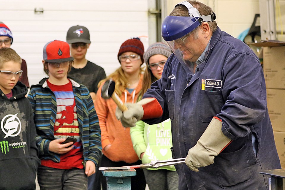 Gerald Neudorf, right, an industrial mechanics instructor at the Nipawin branch of Cumberland College, gives a forging demonstration to Gronlid Central School students Feb. 10. Review Photo/Devan C. Tasa