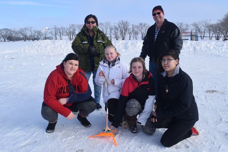 With Karen Tourangeau, commanding officer of the Kamsack air cadets, watching and with instruction by 2nd Lt. Wade Stachura (at back), the Canora cadets’ training officer, members of the Kamsack air cadet squadron who helped blast model rockets into the sky on January 28, from left, were: Hayley O’Conner (a Canora cadet), Tara Taylor, Megan Rafford and Ava Tourangeau.
