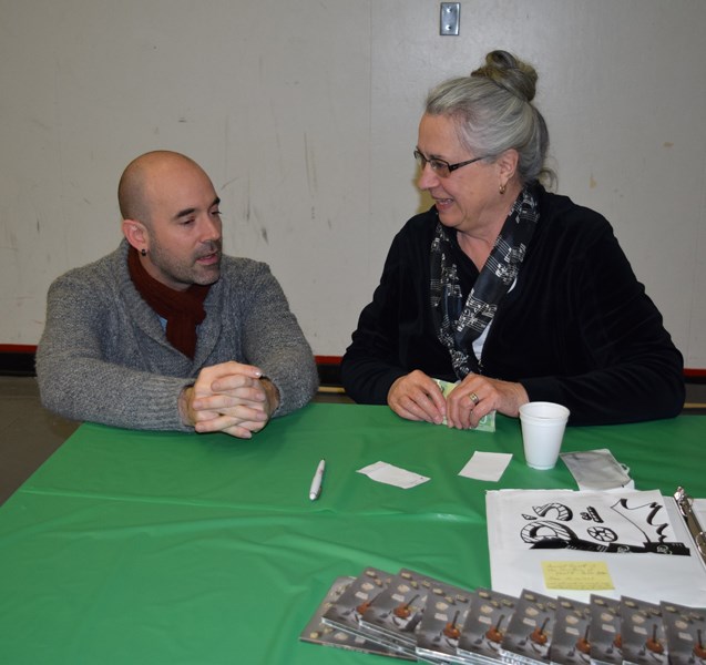 Eric Harper, flamenco guitarist who performed in concert at the CCS auditorium February 6, chatted with Joan Foreman of Canora while she sold his CDs to audience members.