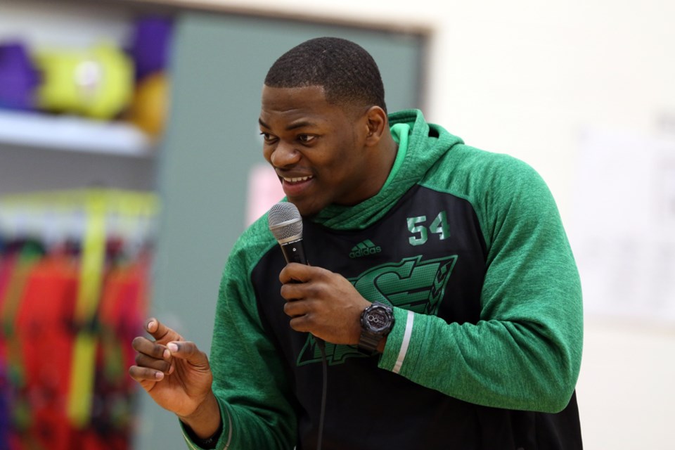 Henoc Muamba, a linebacker with the Roughriders, spoke to the student of Tisdale Elementary about the importance of working hard, having friends who'll support you and believing in yourself. Review Photo/Devan C. Tasa