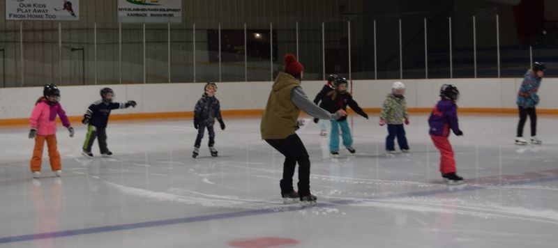 Instructor Jenna Bowes, centre front, demonstrates the correct way for the skaters in her advanced Learn to Skate class to come to a stop while on the ice.