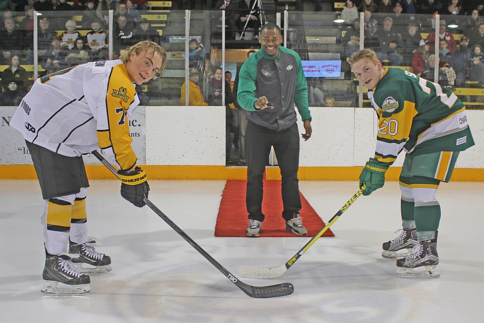 Henoc Muamba, centre, does the ceremonial puck drop. Review Photo/Devan C. Tasa