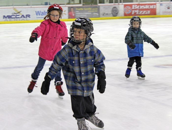 Left to right: Ashley Andrusiak, 9, Ellis Lowe, 7, and Smith Lowe, 5, skate at Gallagher Centre.