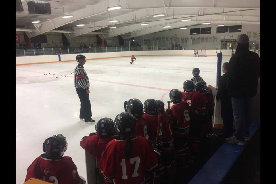 The players anxiously looking on during the pizza shootout Saturday morning against The Pas. The teams tied the shootout 4-4 and both went home with a pizza gift certificate. The Novice Red team was to enjoy pizza again after their home game against the Canora Novice Black Cobras on February 16. On the bench were: Walker Wolkowski (No. 12 AP, goalie), Colton Bletsky (No. 14), Gabrielle Marcischuk-Butler (No. 17), Kale Strelioff (No. 6), Cale Smith (No. 5), Cayden Kelly (No. 11), Jhett Kelly (No. 16), Ayden Lukey (No. 15), Jack Korpusik (No. 9) and Natalia Kelly. Coaches are Greg Smith and Jarod Butler. Kaelyn Shukin is skating and Westin Lindgren is coming back around the bench after shooting.