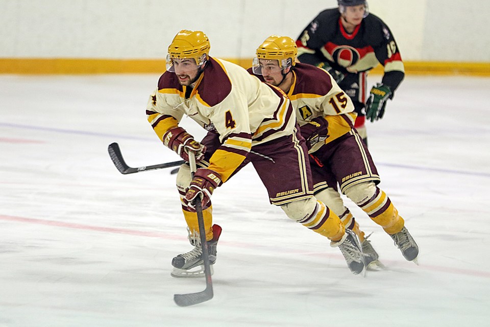 Outback Thunder players Chandler Ashcroft, front, and Logan Robinson rush forward with the puck during the second game of the semifinals against the Saskatoon AGI Insurance Quakers Feb. 26. Review Photo/Devan C. Tasa