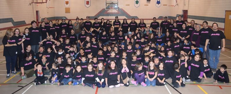 Because there would be no school on February 22, which is the Canadian Red Cross’s Pink Shirt Day, which is a day to focus on the harmful effects of bullying, on Friday the students and staff of Chief Gabriel Cote Education Complex put on their T-shirts containing slogans against bullying and assembled in the gymnasium for a group photograph. “It is so important that victims of bullying know they are not alone and there is help and support available,” says the Red Cross’s Pink Shirt Day website. “Wearing a pink shirt on this day sends a strong message to them that others care. Often, the simple act of wearing a shirt can start conversations, and conversations can be a big step towards healing and helping. In addition, the school plans to conduct a walk on the highway in May when everyone will again be wearing their T-shirts and many will carry placards protesting bullying.