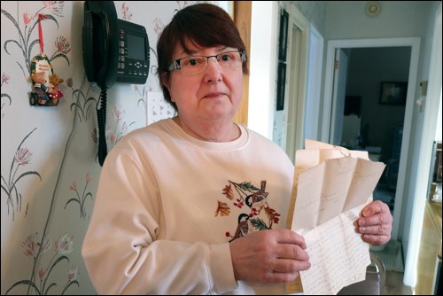 Cynthia Fedak with a three-page letter discovered inside a wall in a Terrace Avenue home.