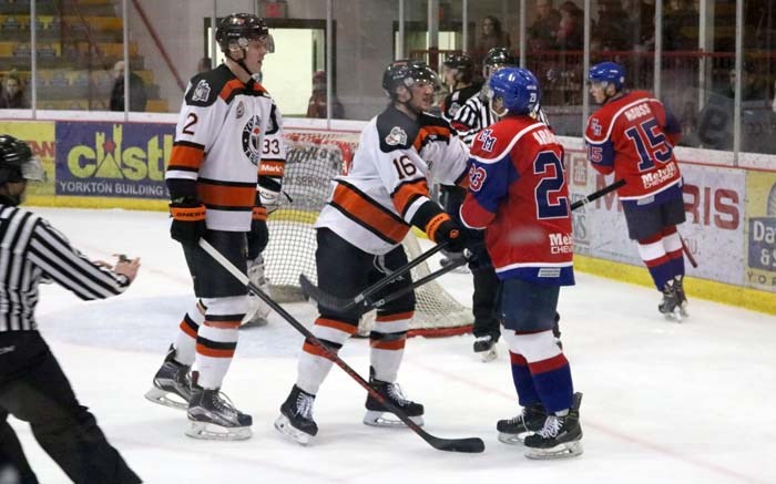 Terriers’ D-man Tyler Baier grabs jerseys with a Millionaires player when the two teams last met in February. The next two-game series takes place this weekend, for the last regular season action before the SJHL playoffs.