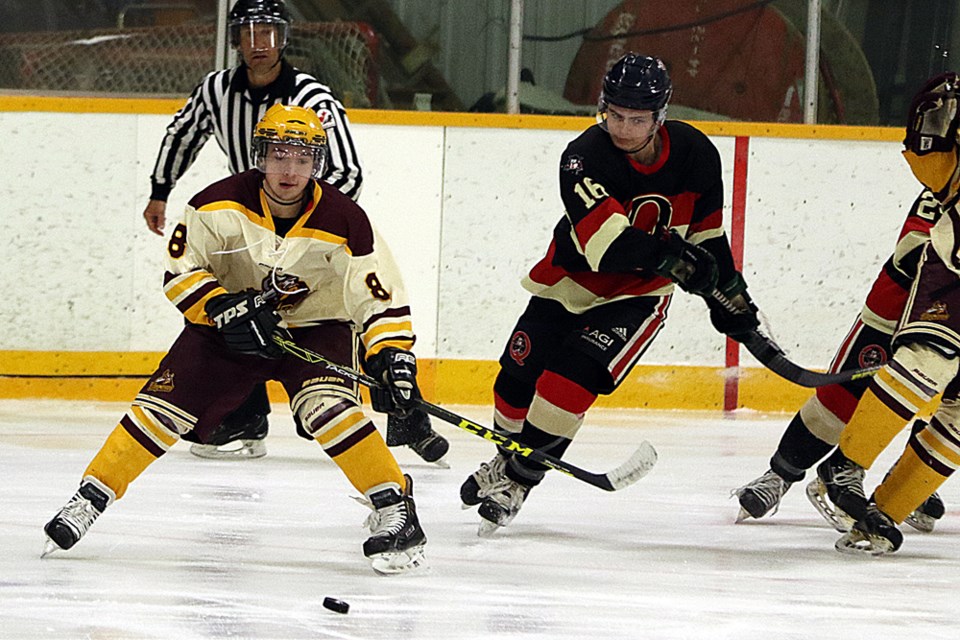 Damian Ingram of the Outback Thunder prepares to hit the puck during Game 3 of the Prairie Junior Hockey League North Division semifinal series March 2. Review Photo/Devan C. Tasa