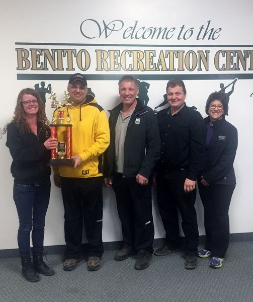 Winning the first event of the Benito bonspiel on February 19 was the Mark Maga rink which was comprised of, from left, Mark Maga (skip), Glen Maga (third), Robert Vessey (second) and Andrea Maga (lead). Kim Pierce presented the trophy on behalf of Benito Premium Meats, the event sponsor.