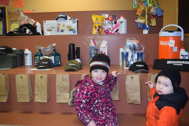 Kayla and Tanner Barrowman of Yorkton had fun putting their coupons into the bags for raffle prizes during the Togo snowmobile derbies on February 19.