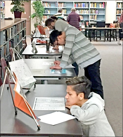 John Paul II students learn about residential school history while visiting components of a popup museum set up in the school library. Photos submitted
