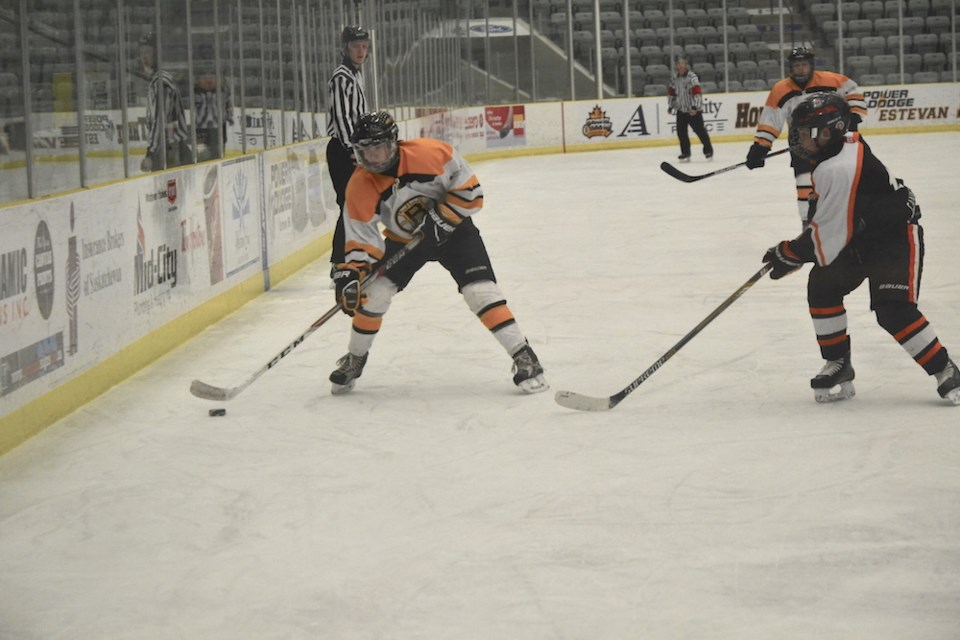 Kaden Chrest with the Estevan Westmoreland Coal peewee AA Bruins maneuvers the puck around a Yorkton