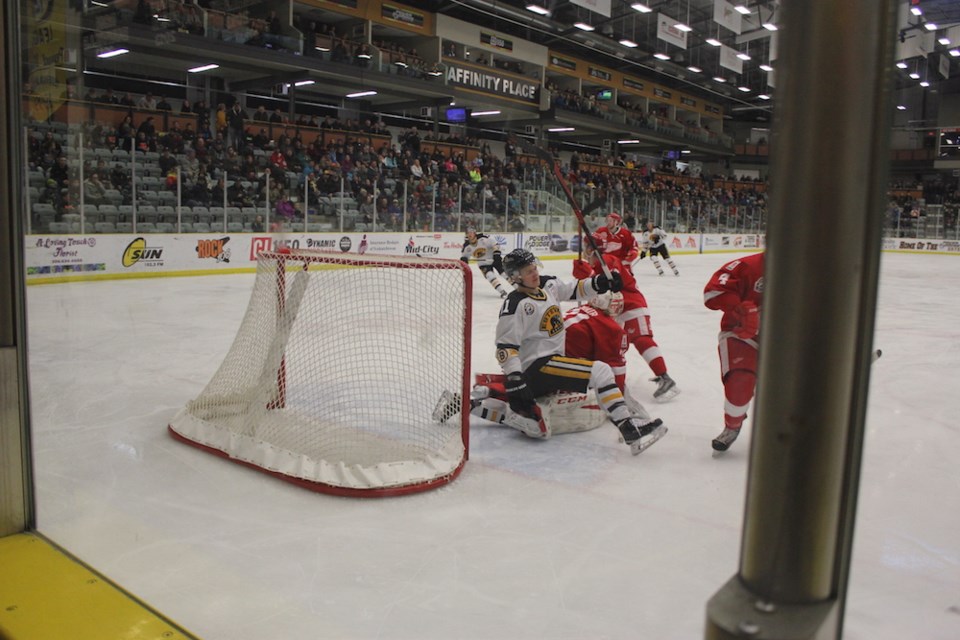 Bruins forward Matt McNeil averts a collision with Red Wings goaltender Carter Phair during the Brui