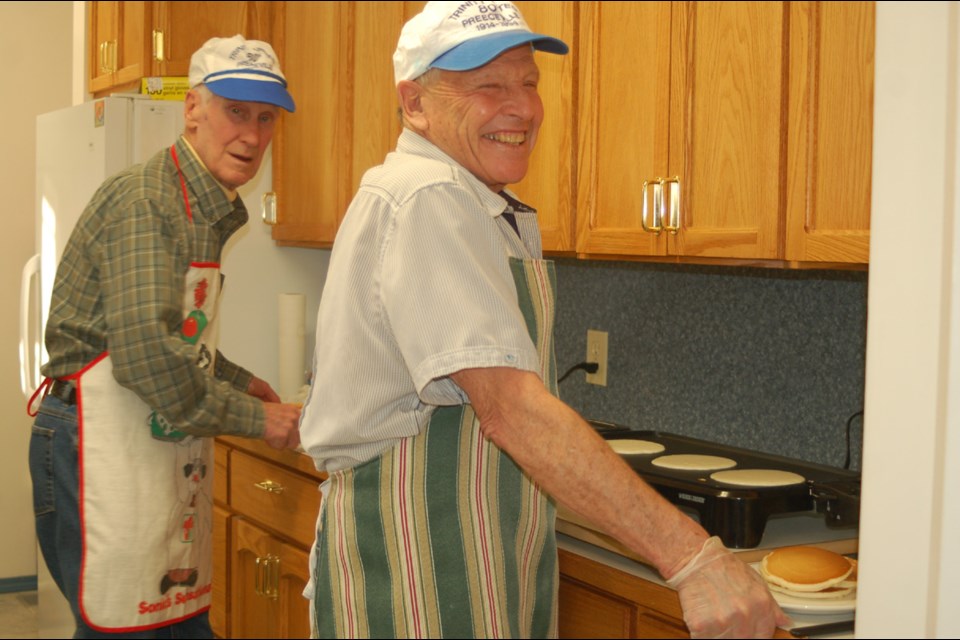 Greg Kennedy, left, and Ron Jaques helped serve pancakes during the Shrove Tuesday supper at Preeceville.