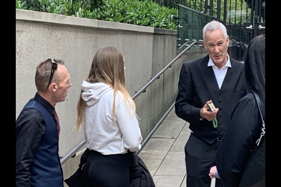 Crown prosecutor Brendan McCabe talks with a member of murder victim Kimberly Hallgarth's family outside B.C. Supreme Court.