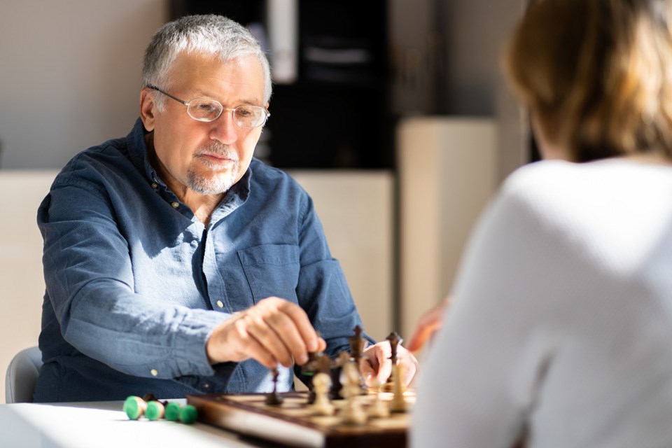 Elderly seniors playing chess to help stay mentally agile.
