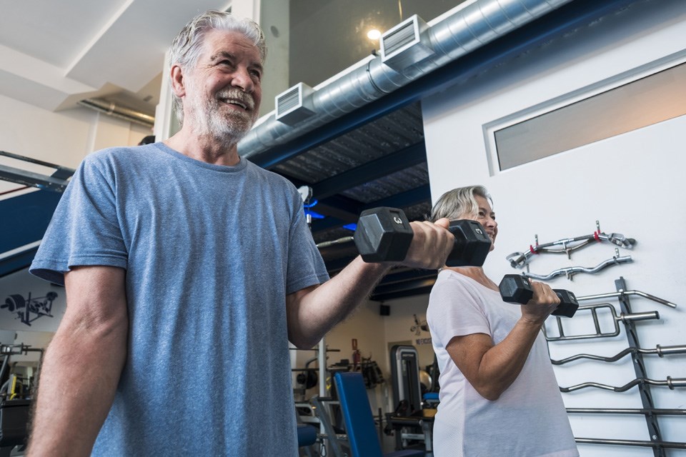 Seniors at the gym doing exercise to stay fit