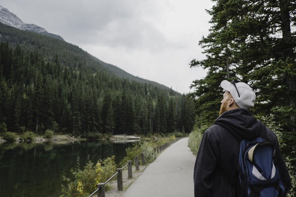 9-2 man-looking-away-at-mountain-and-trees-canmore-c-2022-03-04-01-41-28-utc