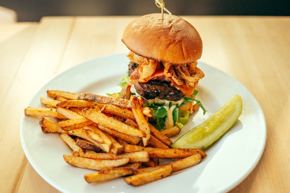 A big old burger with a side of fries from the much-loved Johnny’s Eatery in Athabasca, Alberta. / Johnny’s Eatery