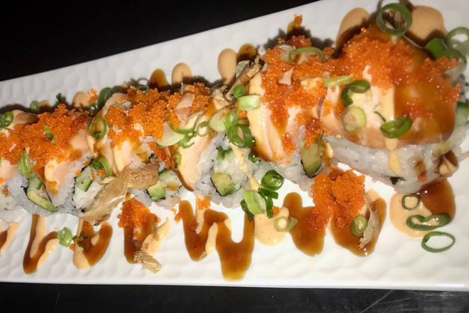 A delicious sushi roll from Okinawa Sushi in Alberta covered in sauce and several toppings. / Okinawa Sushi | Facebook