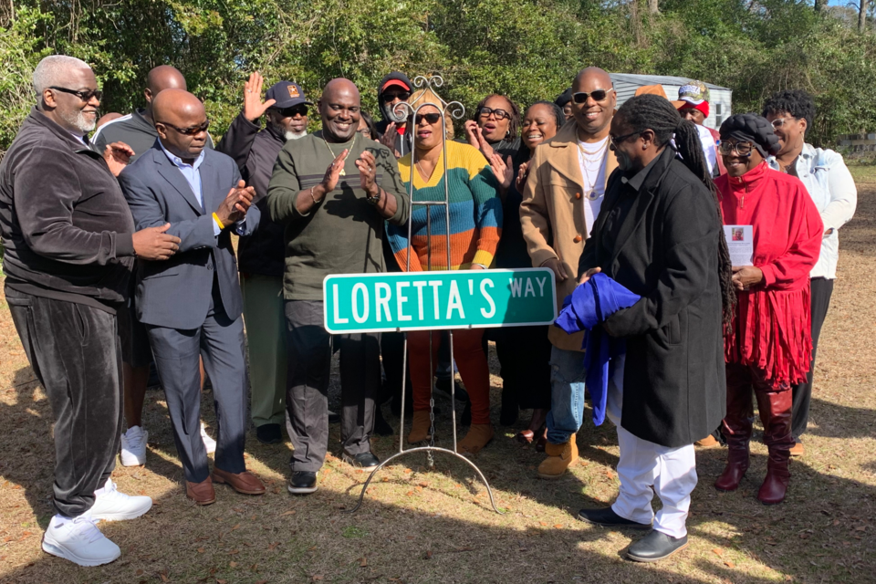 Family of Loretta J. Williams unveiling new street sign. 