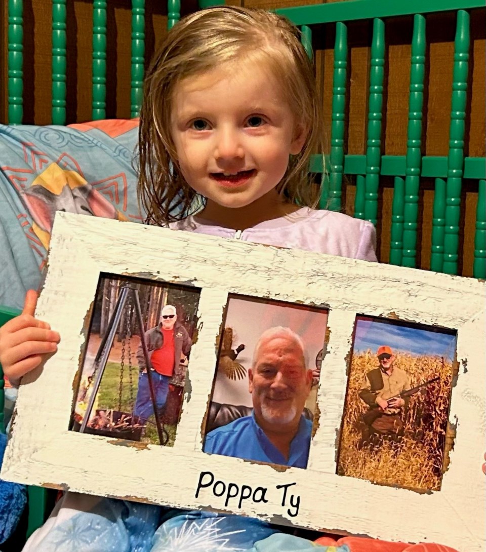 granddaughter-of-ty-cobler-holding-picture-frame-of-ty-in-it