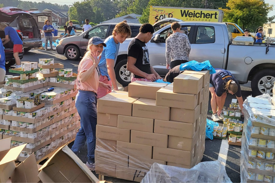 Local Emergency Department physician Dr. Ruthie Crider (waving) caught volunteering at Feed the Boro