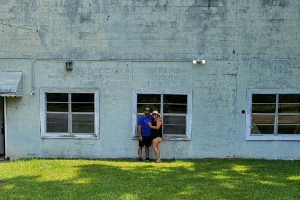 Shawn Coulter and Jennifer Durrence in front of their home which was an old commercial building the couple renovated into a home.