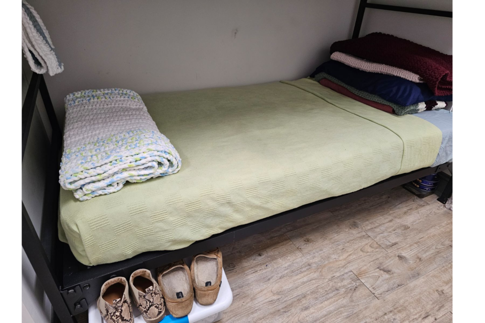 An afghan neatly folded on a resident's bed.