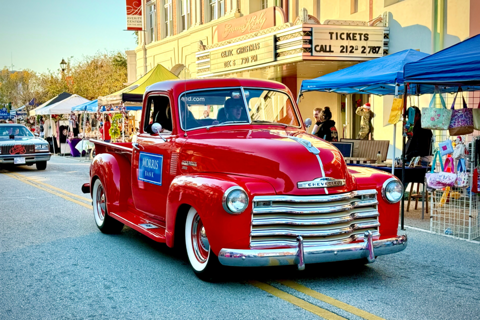 The Christmas Queen Trish Tootle in the Santa Red Morris Bank truck strolling by in the parade.
