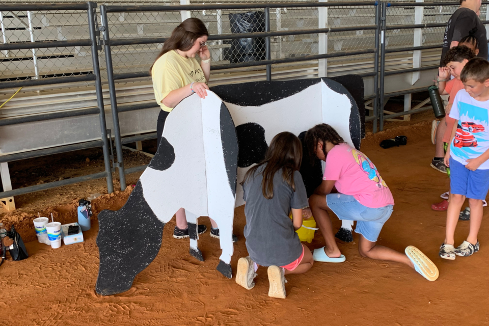 Summer campers participate in hands-on cow milking stimulation with SEBHS FFA Students.