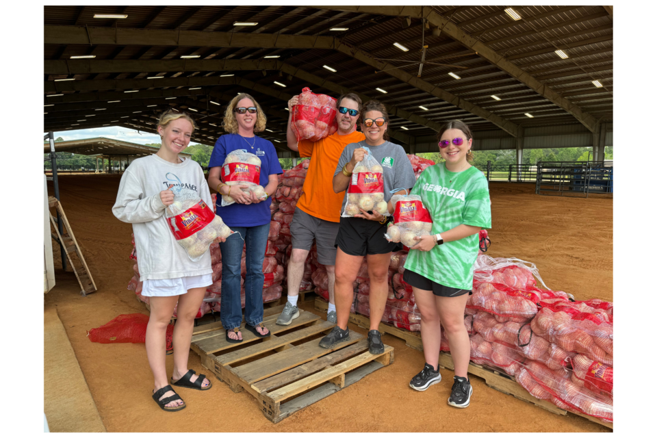 The 4H team was all smiles as they sent families on their way with their fundraiser onions. 