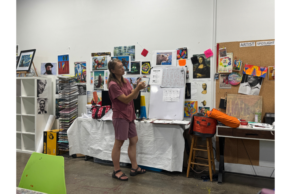 Kanae Collins teaching kanji, the amalgamation of Chinese and Japanese characters that results in a logographic type of art. 