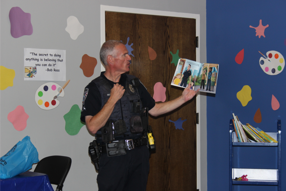 Officer Larry Futch reads to a group of local children at the Statesboro-Bulloch County Library at the first "Storytime with a Police Officer."