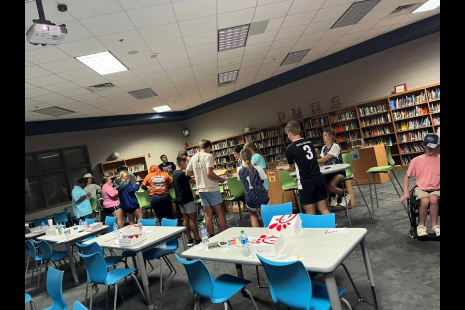 The PMHS Chick-fil-A Leader Academy members bag books for elementary students