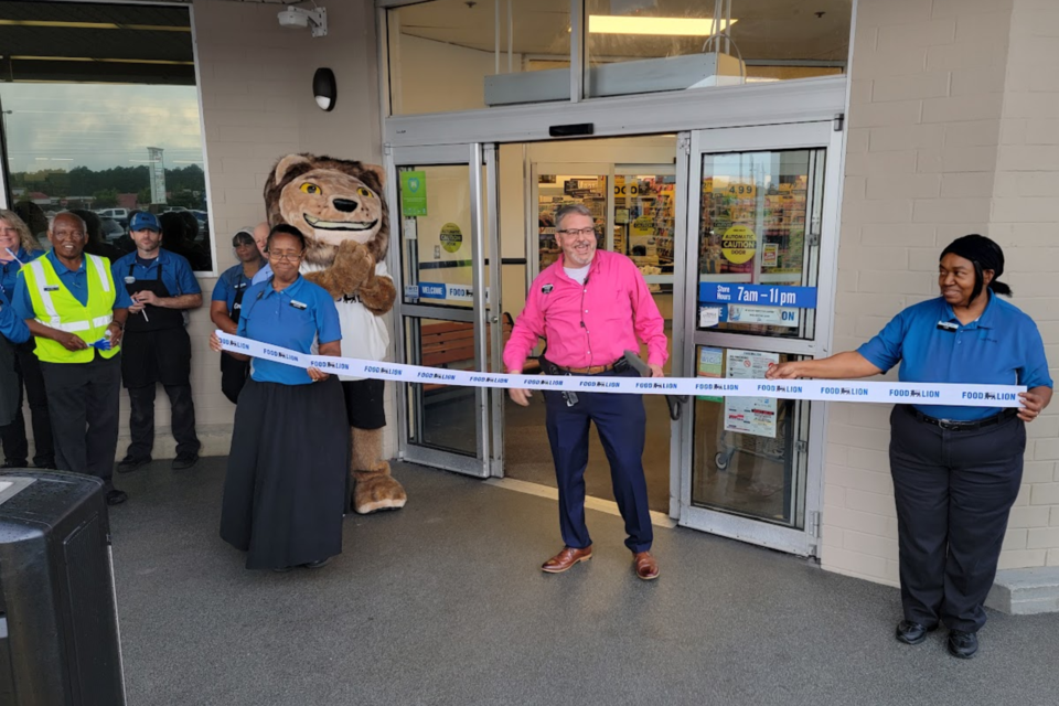 Tod Marsh, store manager, and his team preparing to cut the ribbon