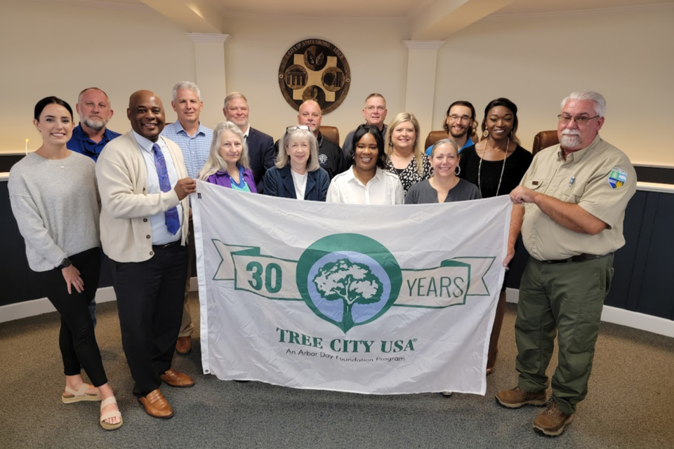 Robert Seamons presents flag to Tree Board and Council