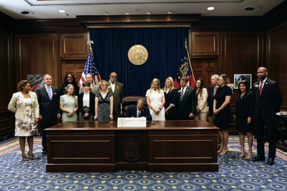 Governor Kemp with Representative Lehman Franklin and supporters of the bills