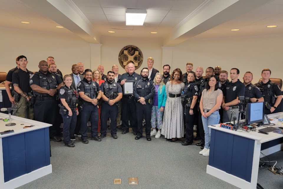 SPD officers, City Council and Chief  Mike Broadhead (C) with Officer Nicholas Sparks-Hoskins (L of Chief) and APO Joey Deloach (R of Chief)