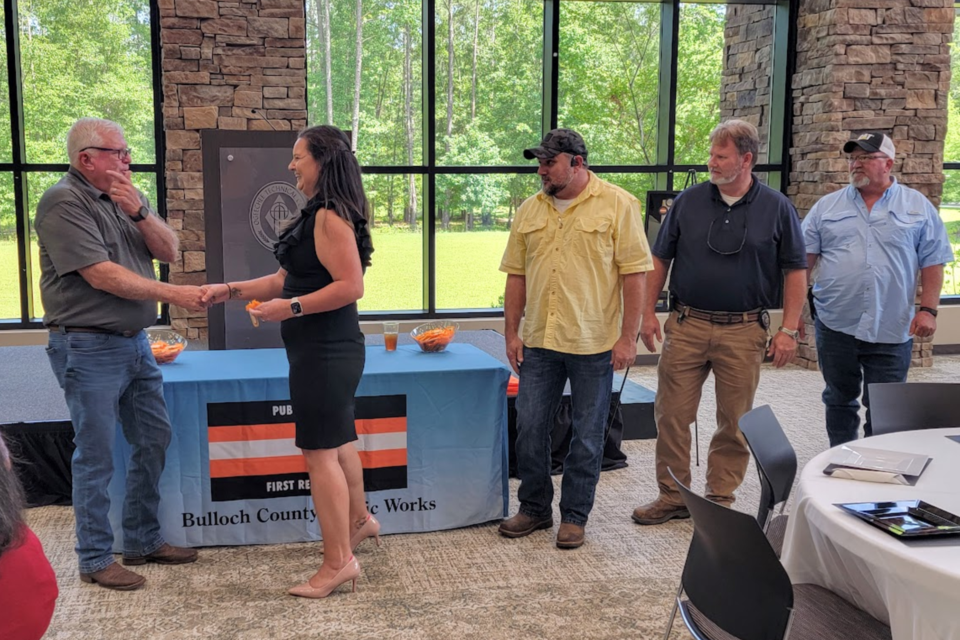 Dink Butler presents Alexis Knox with a Challenge Coin.