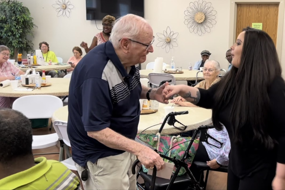 Alicia cutting a rug with one of the seniors