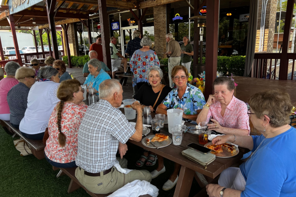 Young at Heart members enjoying pizza.