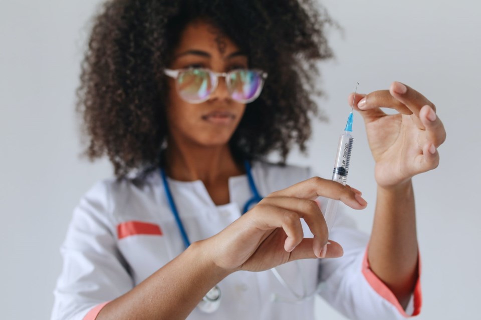 woman touching the syringe needle