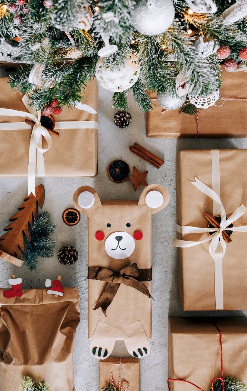 present boxes arranged on floor under decorated christmas tree