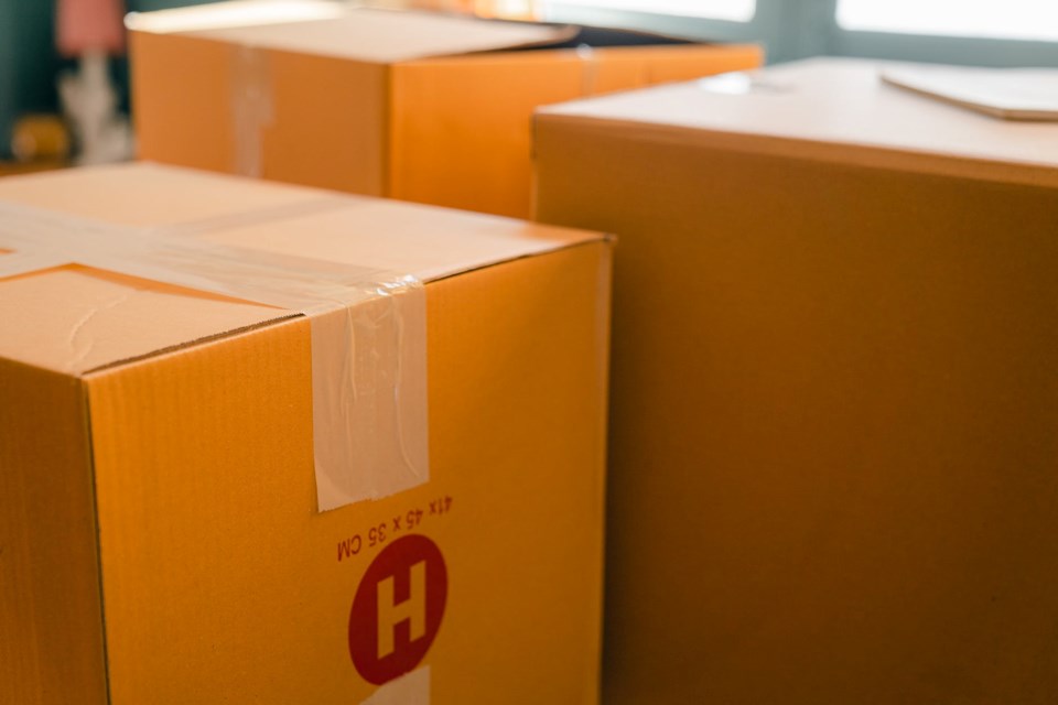 carton boxes near window in sunny room