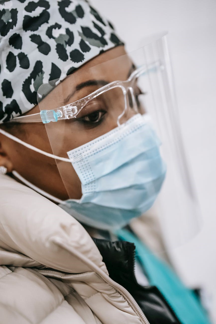 black woman in protective mask and glasses