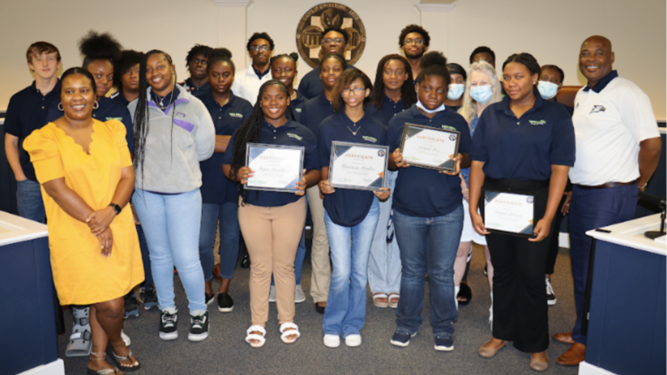 Statesboro Youth Connect Summer Program graduates posing with Mayor McCollar, Venus Mack and Shari Barr.