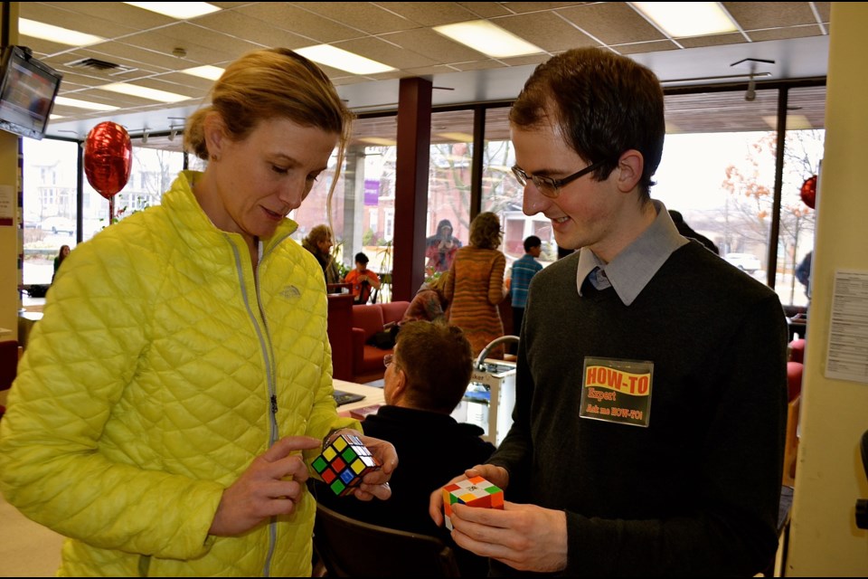 Ben Lorimer shows Lisa Panchuk how to quickly solve a Rubik’s Cube Troy Bridgeman for GuelphToday.com